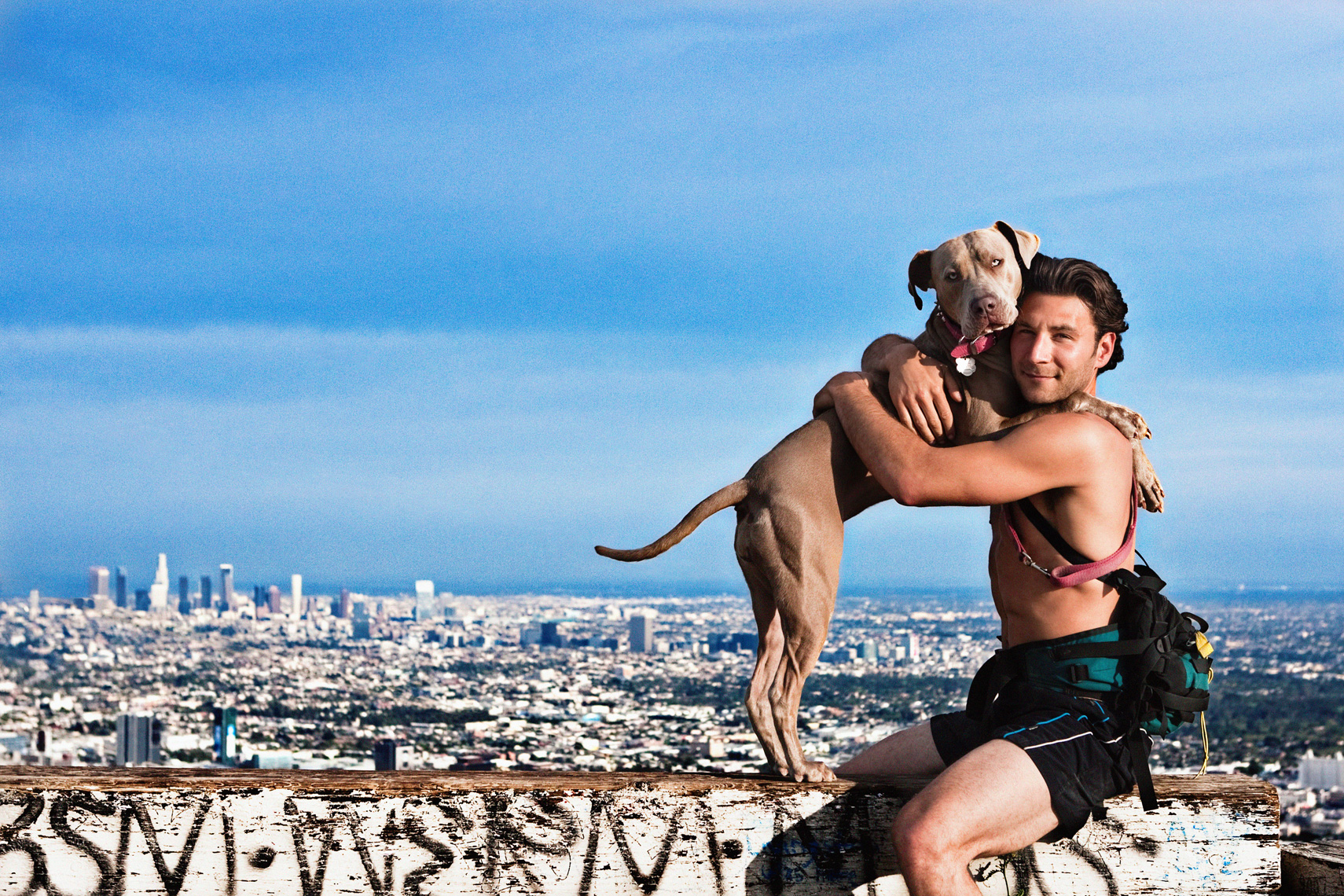 Los Angeles Dog Photography, Michael Brian, Man hugging dog above Los Angeles, Runyon Canyon, Blue Nose Pit Bull 