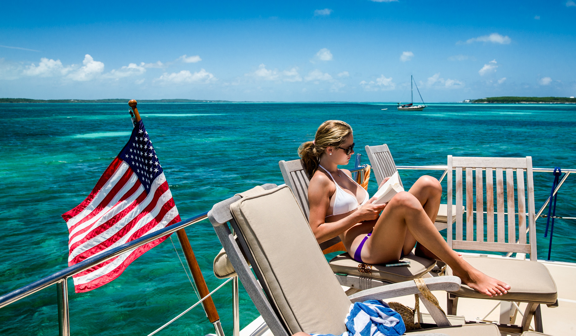 Los Angeles portrait Photography, Michael Brian, dog, pet, cat, lifestyle, Young woman on yacht enjoying the Bahama sun in bikini